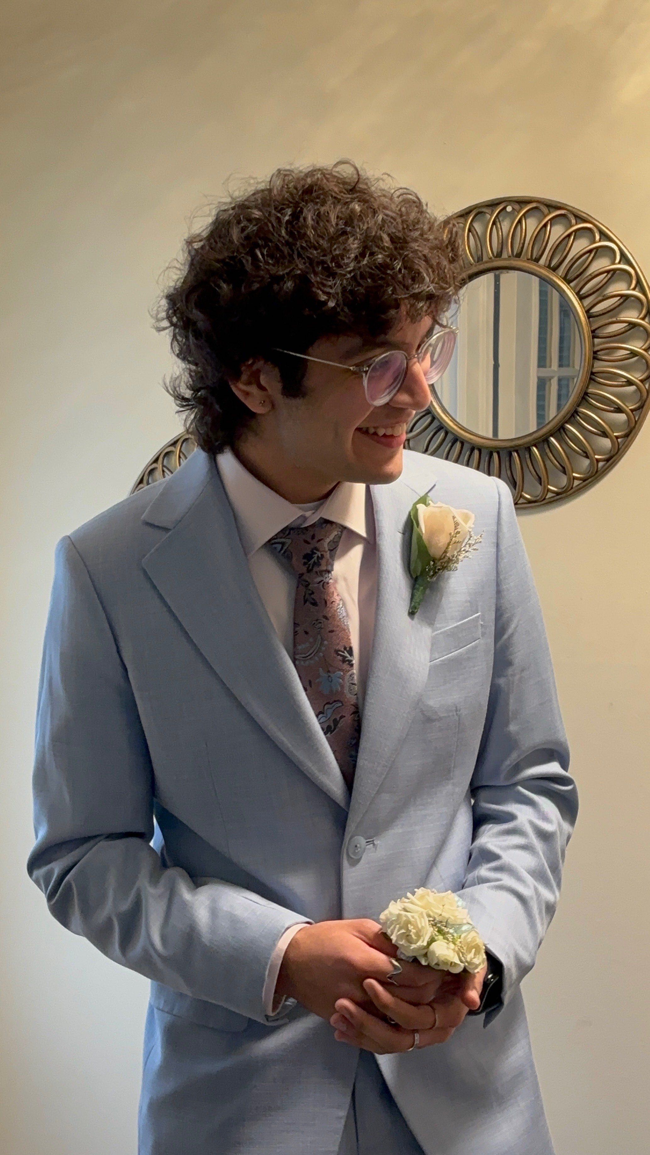 Sukhsimranpreet Chana smiling in a light blue suit