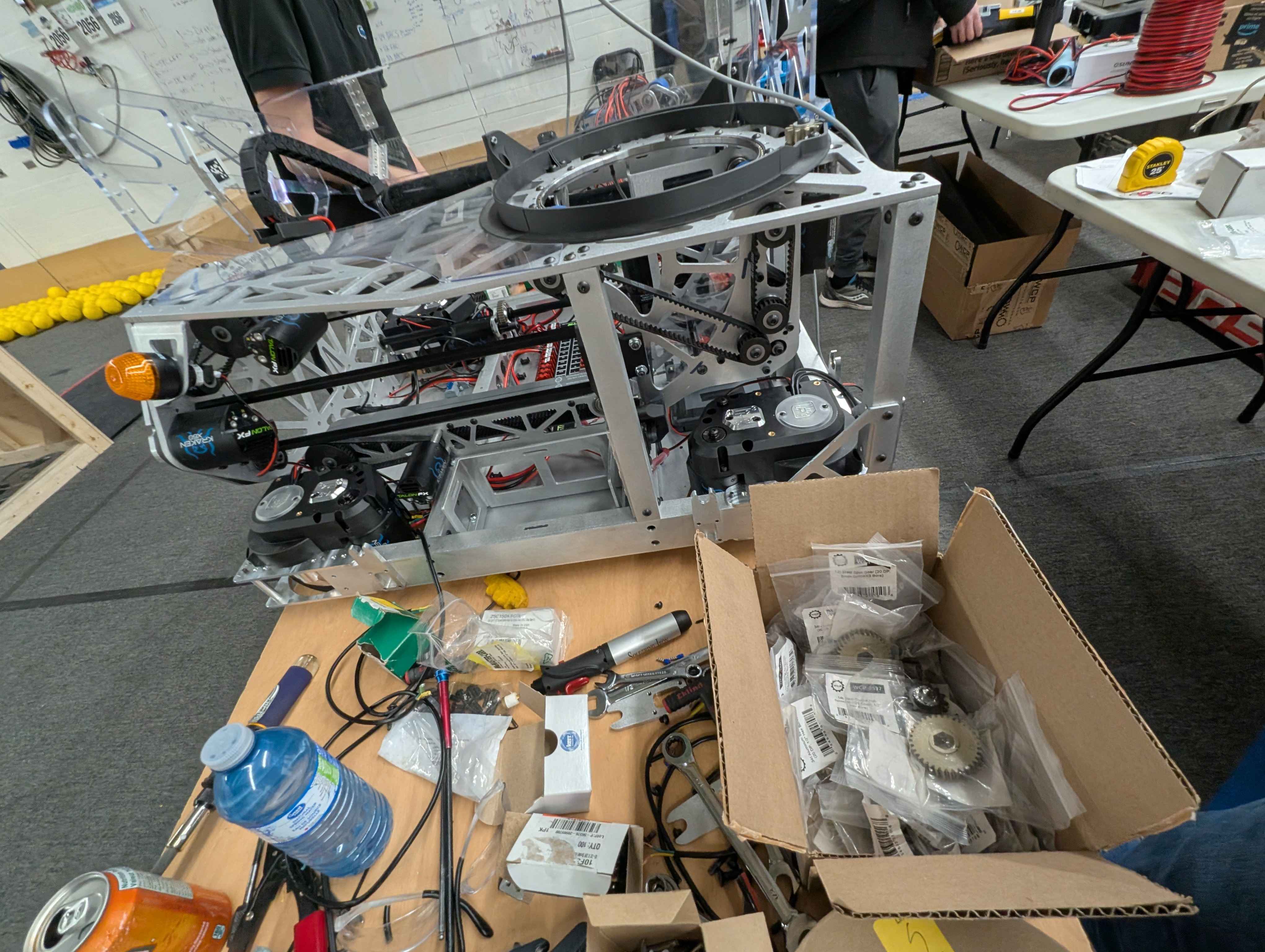 Team 2056 robot surrounded by tools and parts during assembly