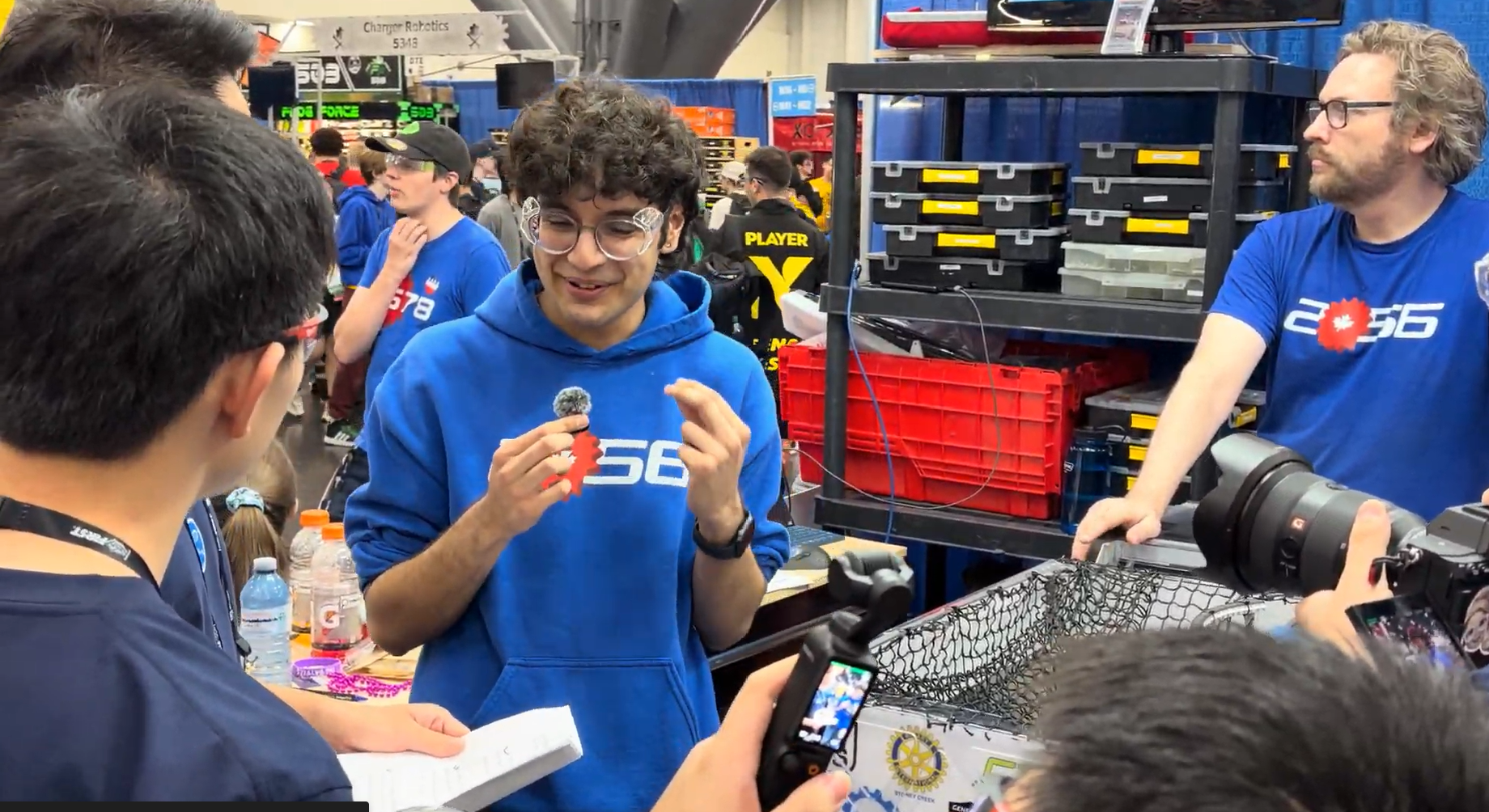 Sukh sharing Team 2056's work during an interview in the competition pit